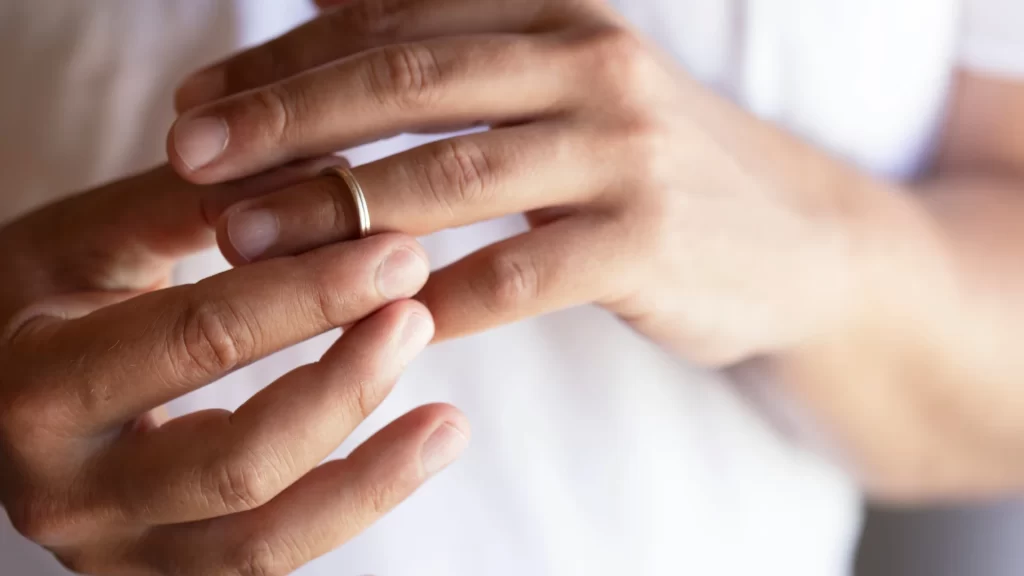 a person negotiating a settlement wearing wedding ring on their finger