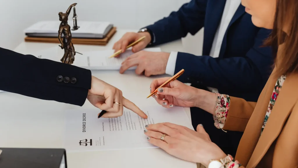 Signing legal documents with pens.
